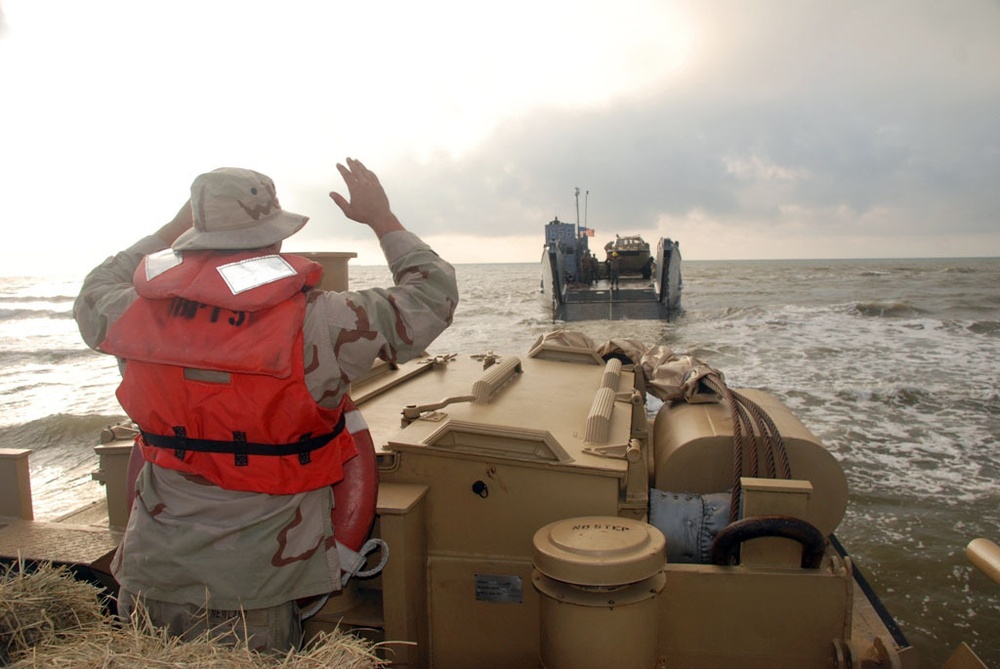 Light amphibious re-supply cargo vehicle delivers hay to stranded cows on Galveston beach