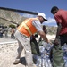 Haitian relief workers help United Nations, U.S. Military personnel unload food, water for hurricane relief