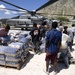 Haitian relief workers help United Nations, U.S. Military personnel unload food, water for hurricane relief