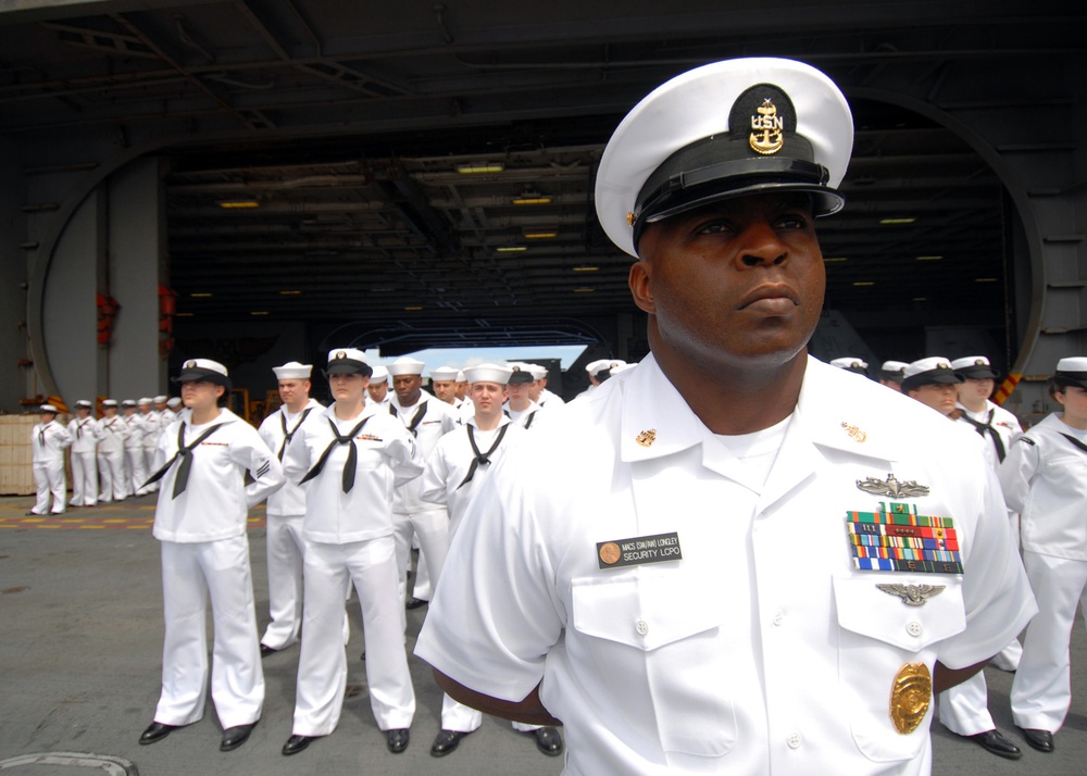 Sailors aboard USS Abraham Lincoln spread ashes of nine former service members during burial at sea