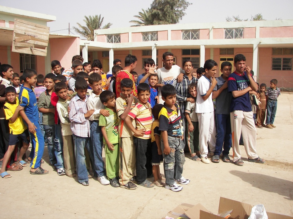 Iraqi Soldiers handout school supplies to children
