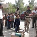 Iraqi Soldiers handout school supplies to children