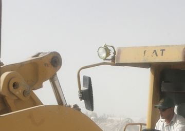 Combat Engineer Tears Down Barriers With Iraqis