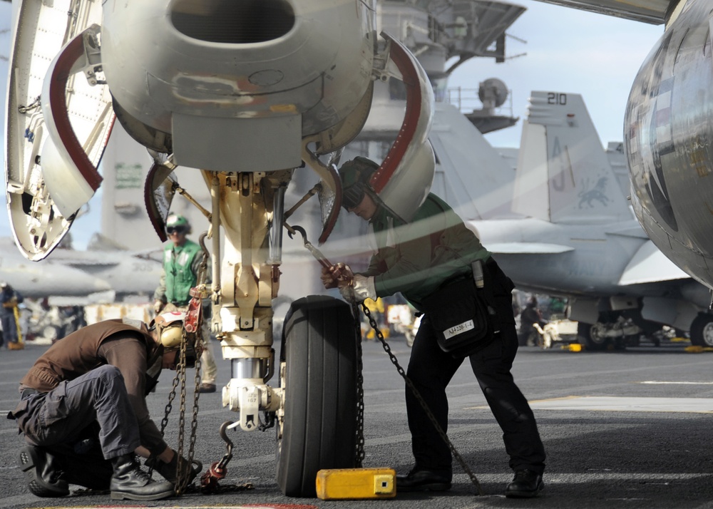 USS Theodore Roosevelt flight deck personnel hard at work