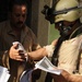 Iraqi Soldiers Distribute Information Pamphlets