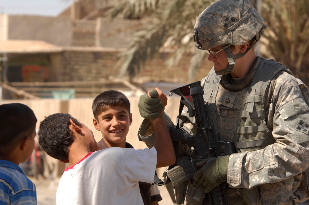 MND-B Soldiers, INP conduct information dissemination, mingle with kids