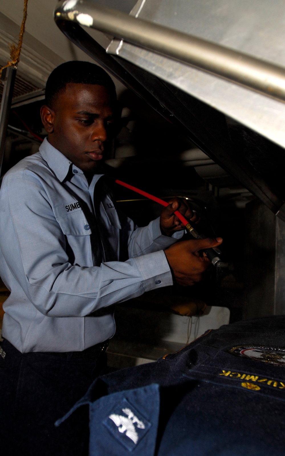 Sewing, steam-pressing aboard USS John C. Stennis