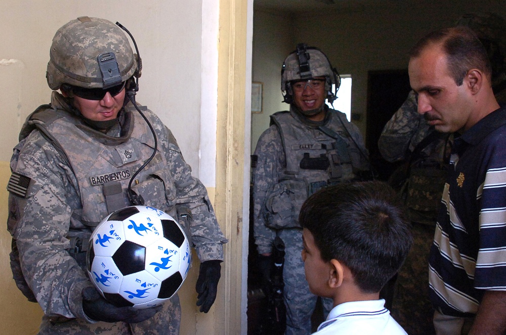 BSTB Soldiers pass out soccer balls to school children in Beladiyat