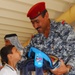 Iraqi national police distribute backpacks, smiles