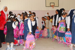 Iraqi national police distribute backpacks, smiles