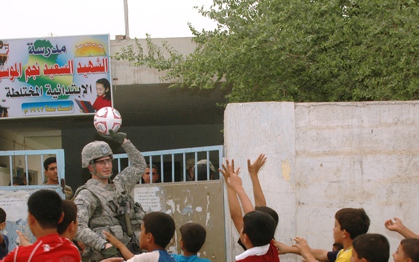 Multi-National Division – Baghdad Soldiers donate school supplies, soccer balls to Iraqi school