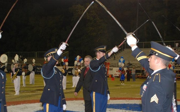 Local National Guard unit presents colors and sabers at area high school