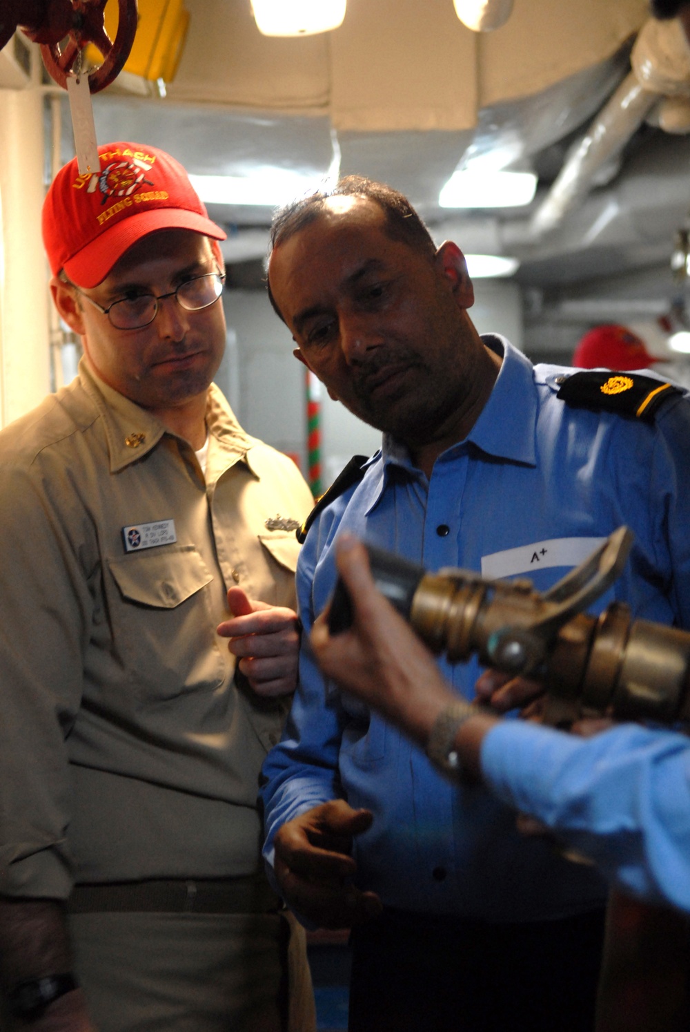 Indian navy sailors witness damage control drill aboard USS Thach