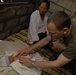 U.S. Navy Doctor Examines Brand New Baby Boy During U.S. Marine Corps Exercise in the Philippines