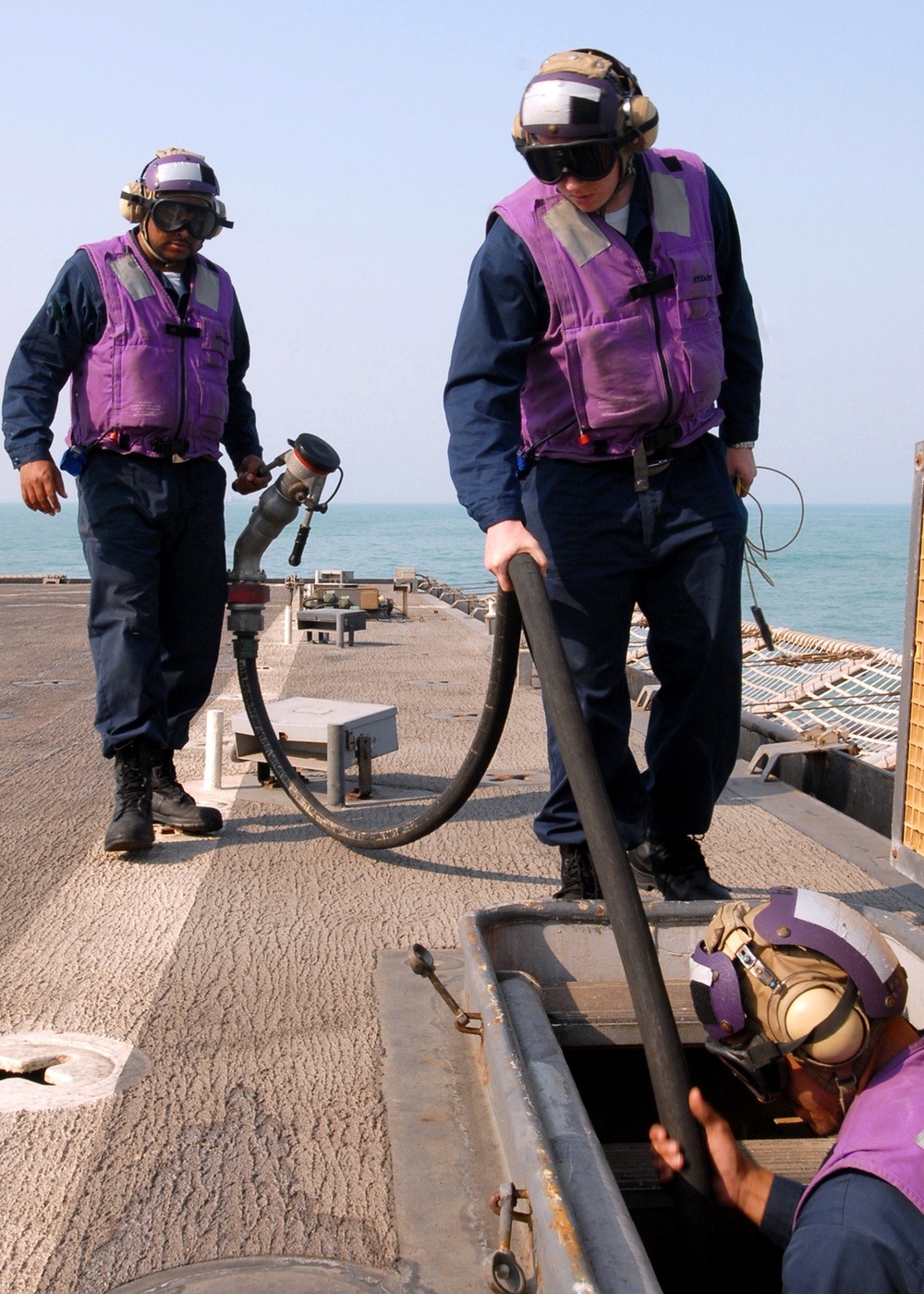 Sailors fuel aircraft aboard USS Carter Hall