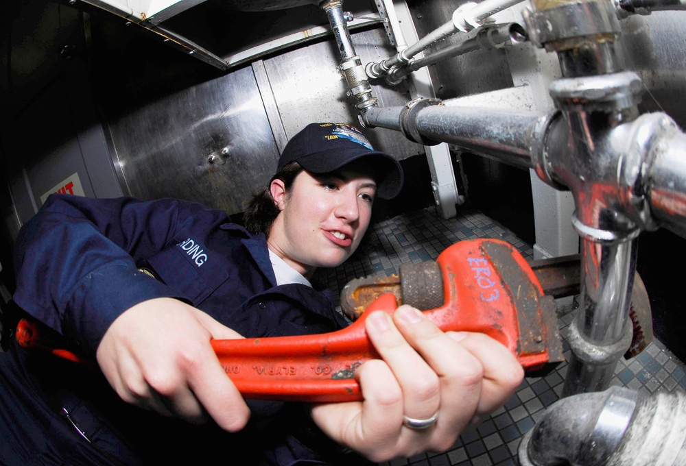 Tightening pipes aboard USS John C. Stennis