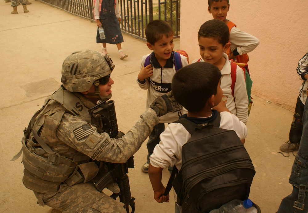 National Police, Tuskers provide backpacks, smiles to young children returning to school