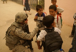 National Police, Tuskers provide backpacks, smiles to young children returning to school