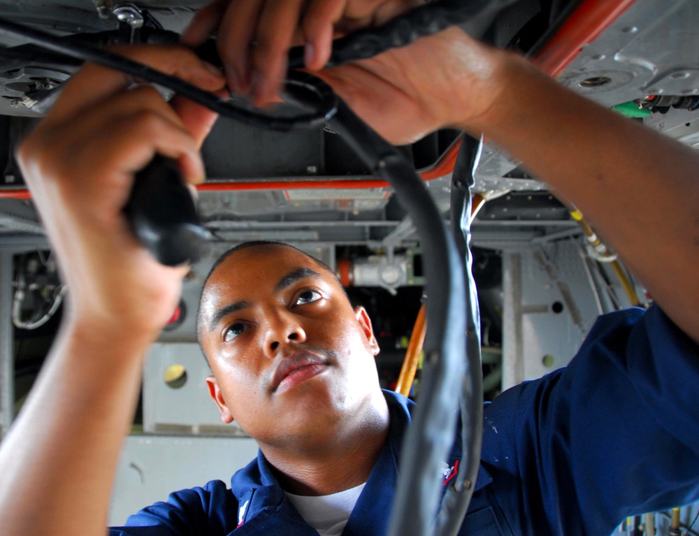 Sailors perform routine maintenance on Sea Hawk helicopter
