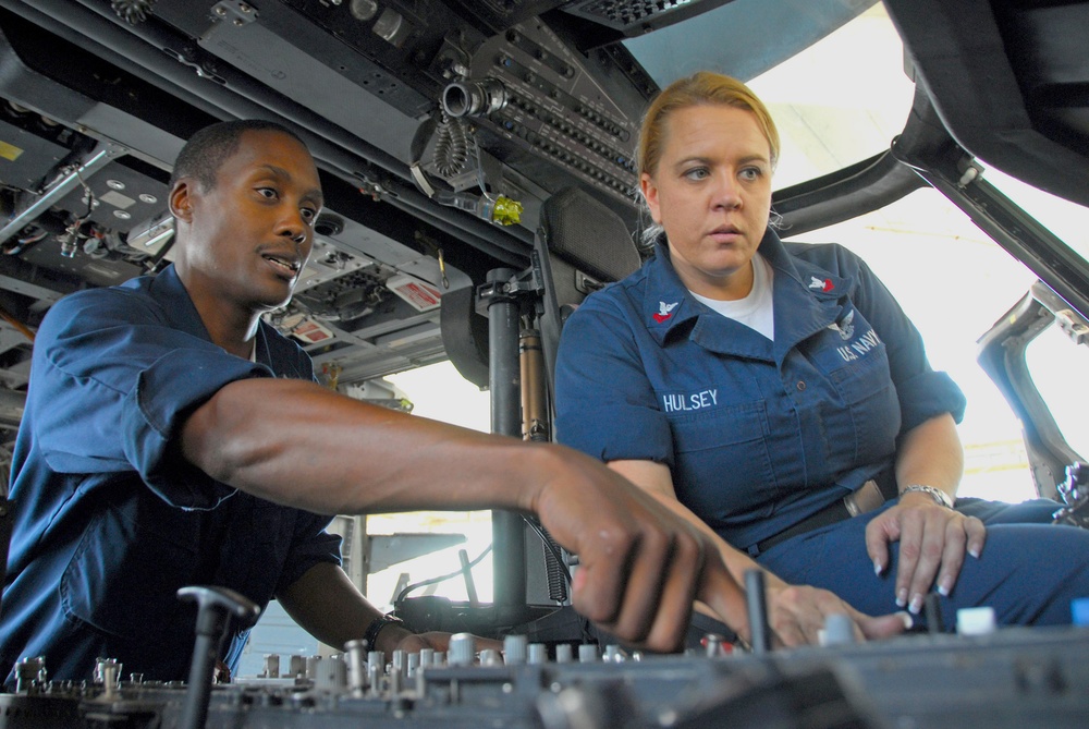 Sailors perform routine maintenance on Sea Hawk helicopter