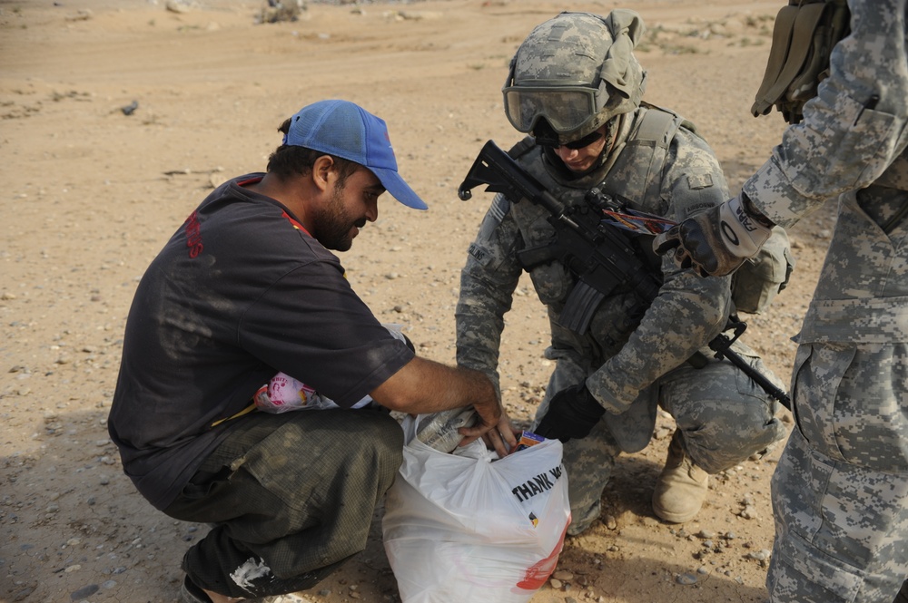 U.S. Soldiers hand out food and supplies