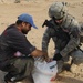 U.S. Soldiers hand out food and supplies