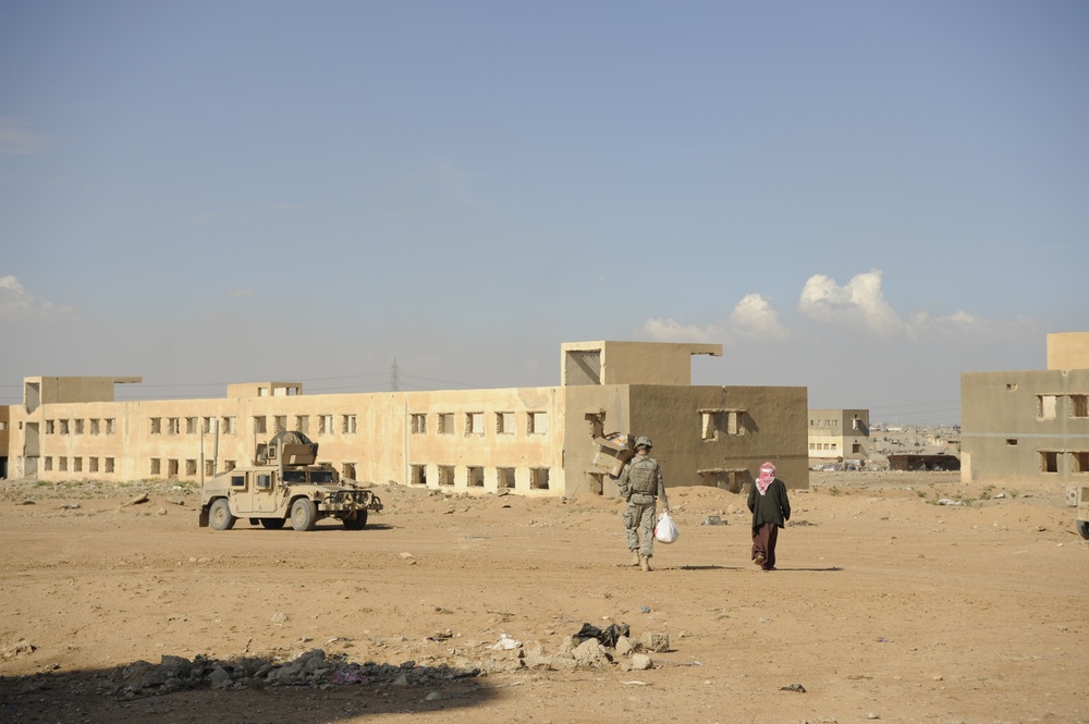 U.S. Soldiers hand out food and supplies