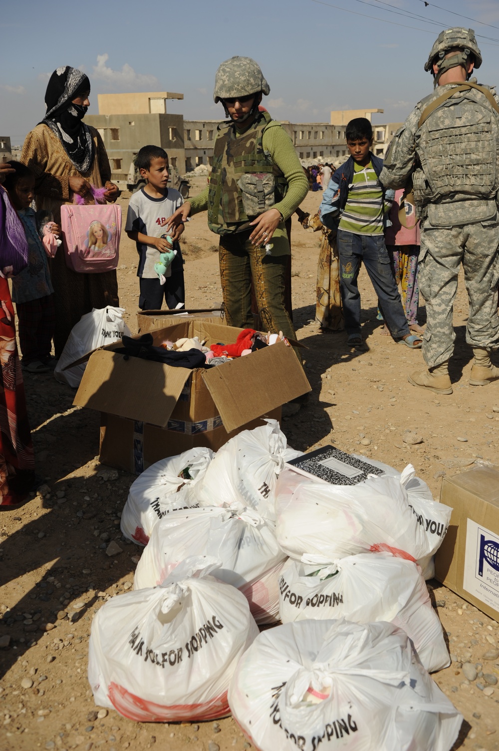 U.S. Soldiers hand out food and supplies