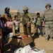 U.S. Soldiers hand out food and supplies