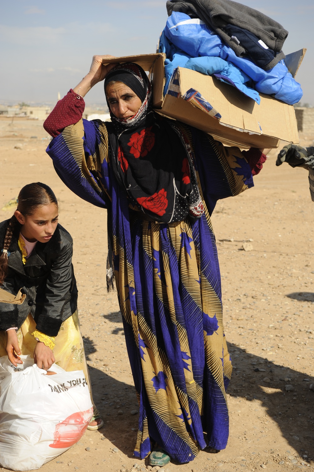 U.S. Soldiers hand out food and supplies