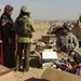 U.S. Soldiers hand out food and supplies