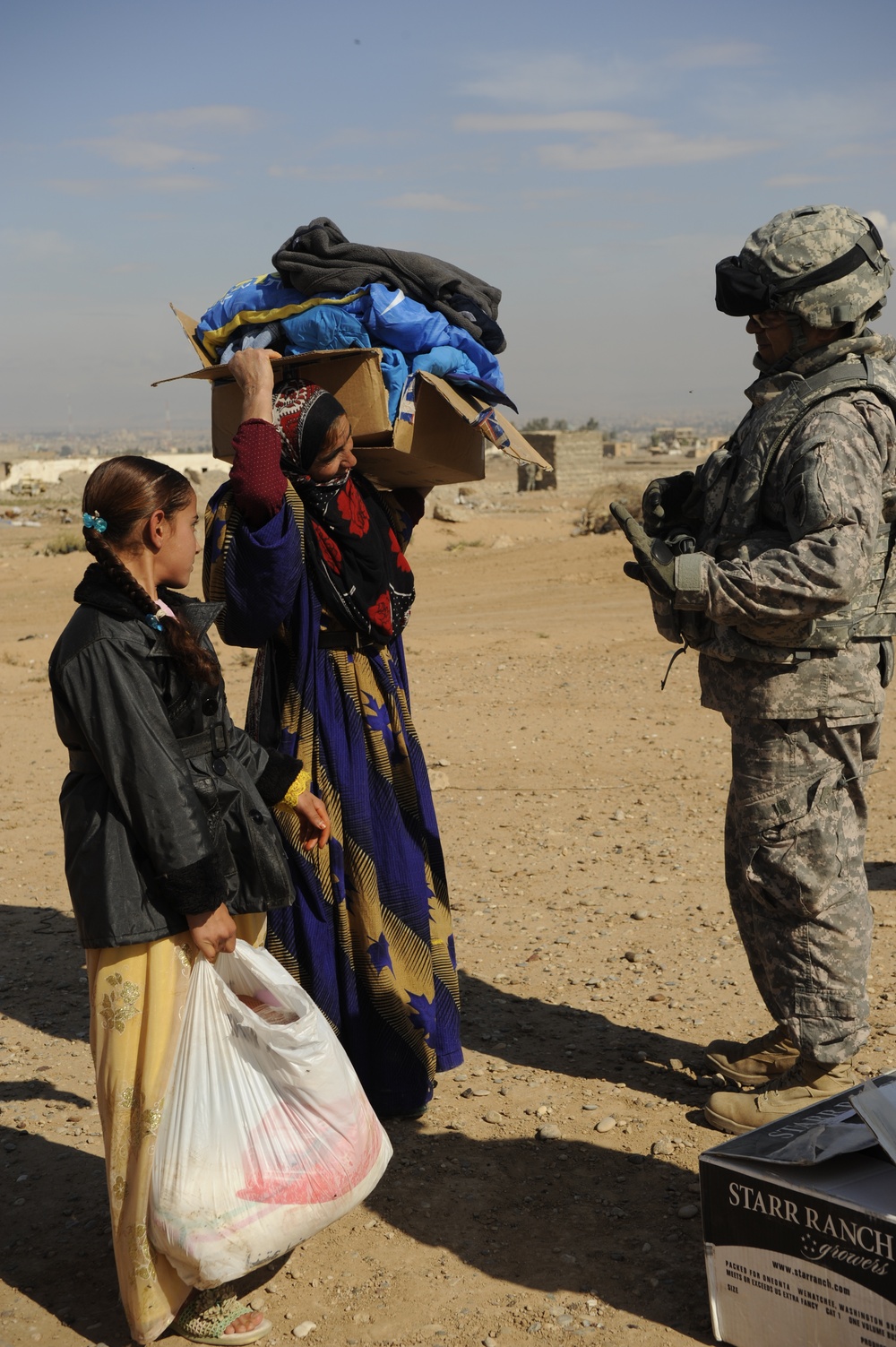 U.S. Soldiers hand out food and supplies