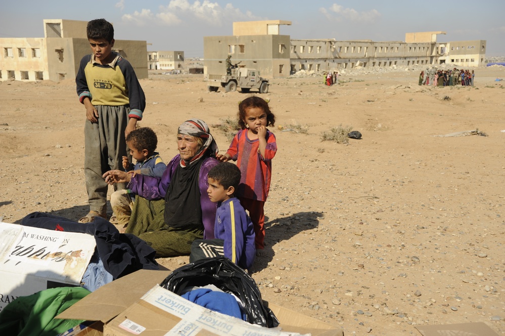 U.S. Soldiers hand out food and supplies