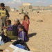 U.S. Soldiers hand out food and supplies