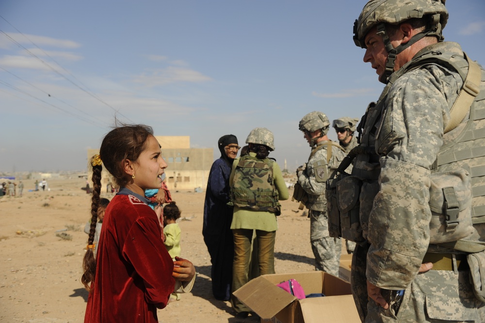 U.S. Soldiers hand out food and supplies