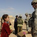 U.S. Soldiers hand out food and supplies