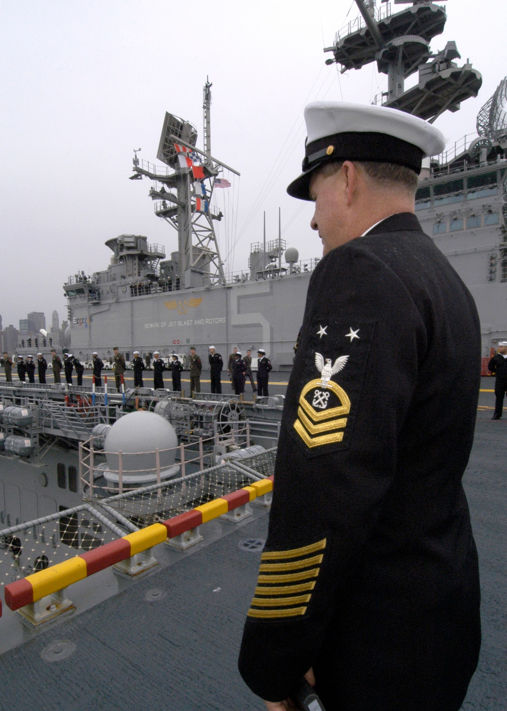 Master Chief Petty Officer Daniel Woodward, from Pittsburgh, Pa., supervises the crew of the amphibious assault ship USS Bataan as they man the rails to enter New York. Bataan is in New York to celebrate Veterans Day and will participate in community rela