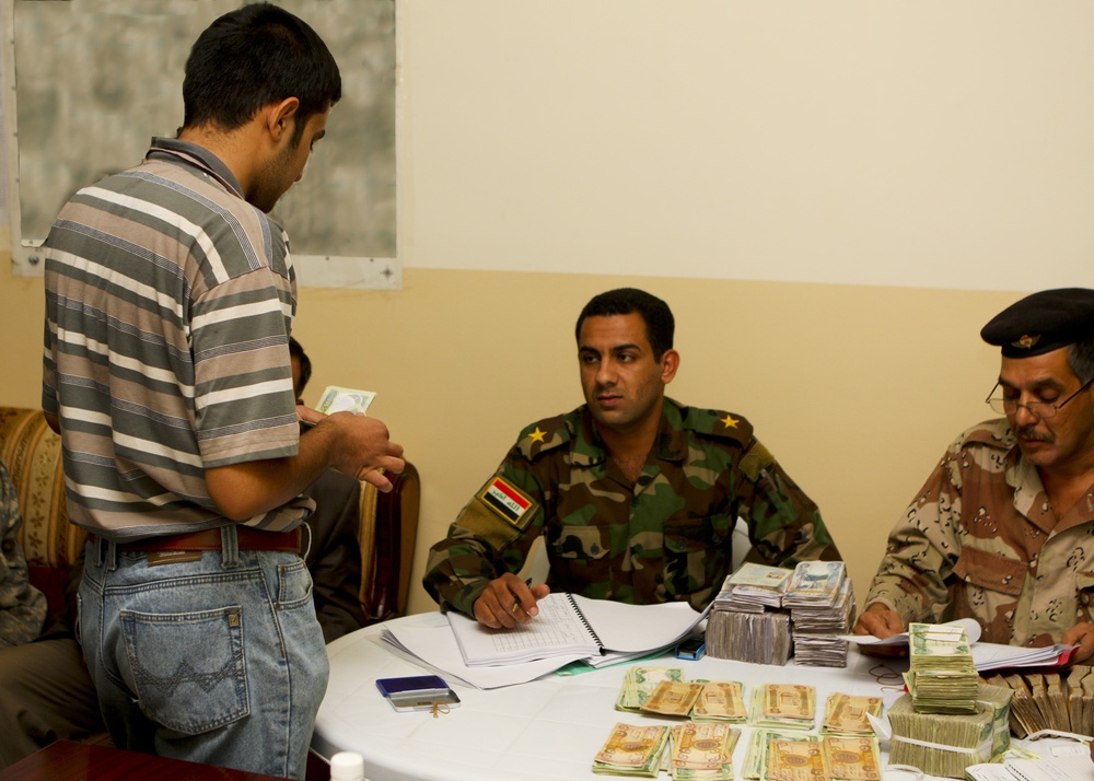 Iraqi government pays its 'Sons': West Rashid Sons of Iraq receive first government of Iraq paycheck