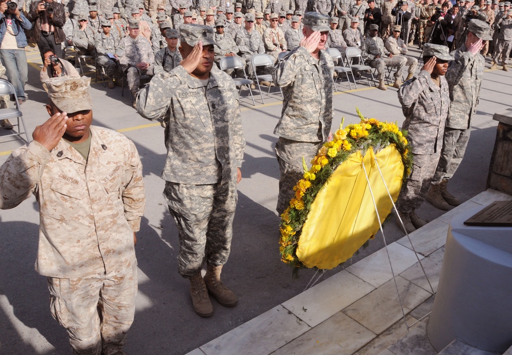 Representatives of each of the services assigned to Combined Security Transition Command - Afghanistan stand at attention after the laying of the wreath during the Veterans Day ceremony held at Camp Eggers in Kabul, Nov. 11, 2008. More than 200 U.S. and c