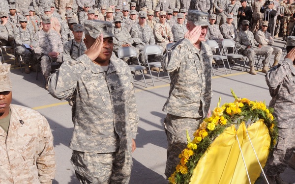 Representatives of each of the services assigned to Combined Security Transition Command - Afghanistan stand at attention after the laying of the wreath during the Veterans Day ceremony held at Camp Eggers in Kabul, Nov. 11, 2008. More than 200 U.S. and c