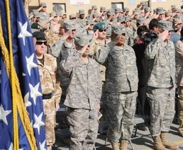 Members of Combined Security Transition Command - Afghanistan stand at attention during the playing of Taps at the Veterans Day ceremony at Camp Eggers in Kabul, Nov. 11, 2008. More than 200 U.S. and coalition forces service members attended the ceremony