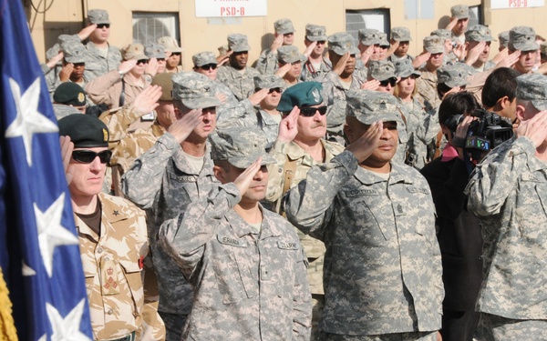 Members of Combined Security Transition Command - Afghanistan stand at attention during the playing of Taps at the Veterans Day ceremony at Camp Eggers in Kabul, Nov. 11, 2008. More than 200 U.S. and coalition forces service members attended the ceremony