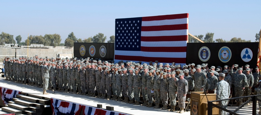Reenlistees salute during the 3rd Sustainment Command's Operation Sustainer Strong at Joint Base Balad, Iraq on Veterans Day.