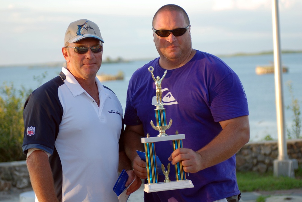 Joint Task Force Guantanamo Trooper Ron Arnaud (right) is presented a trophy by U.S. Naval Station Guantanamo Bay's Morale, Welfare and Recreation Installation Manager Craig Basel for winning both the best booth display and best poultry categories in the