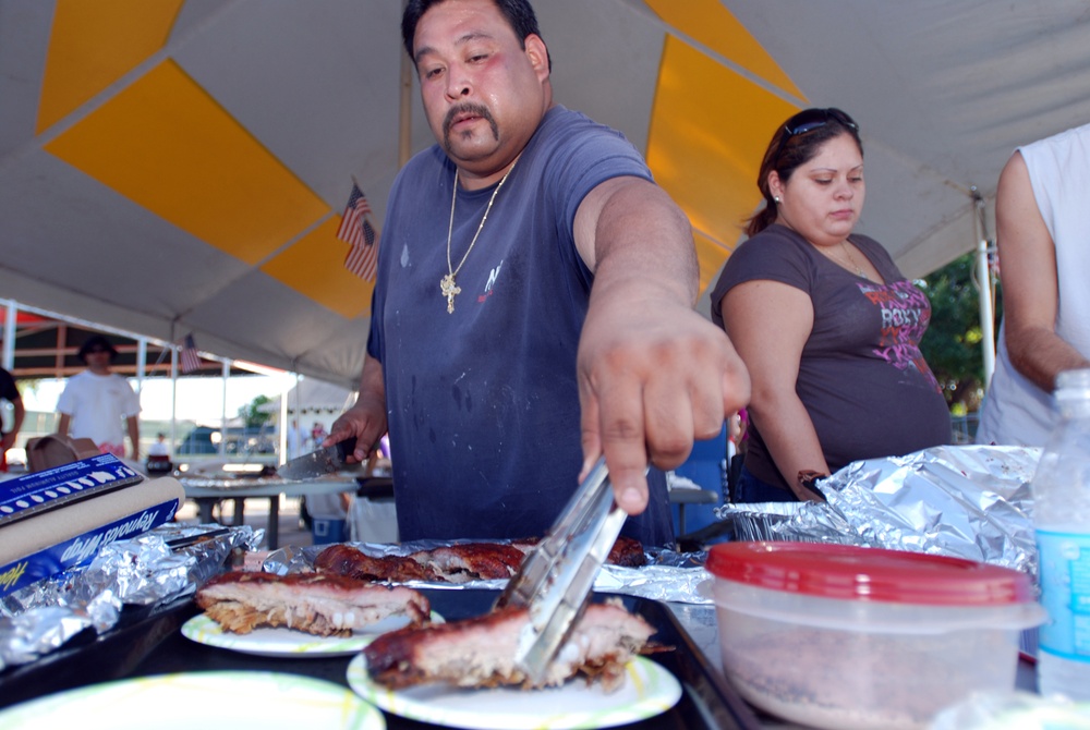 David Manzano plates up a sample of his team's grilled pork ribs to submit for U.S. Naval Station Guantanamo Bay's Morale, Welfare and Recreation Veterans Day Barbecue Competition, Nov. 11. Teams from both the Naval Station and Joint Task Force Guantanamo
