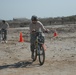 Fresno, Calif., native Capt. Philip Durando, commander, Company C, 589th Brigade Support Battalion, 41st Fires Brigade, poses while racing in the Forward Operating Base Delta Veterans Day Bike Race Nov. 11 at the FOB softball field. The idea for the race