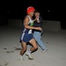 Jaime Ramirez, center, hands out water to an Iraqi physical training leader at Forward Operating Base Rustamiyah, Iraq, on Nov. 11, 2008. Members of the U.S., British, and Iraqi military participated in the 10k Veterans Day memorial run.