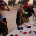 British and Iraqi military members sign up before running the 10k Veterans Day memorial run at Forward Operating Base Rustamiyah, Iraq, on Nov. 11, 2008.