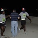 Jaime Ramirez, center, hands out water to soldiers during the 10k Veterans Day memorial run at Forward Operating Base Rustamiyah, Iraq, on Nov. 11, 2008.