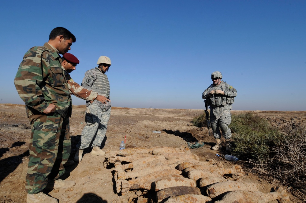 Iraqi army Explosive Ordnance Disposal team clear base of old munitions